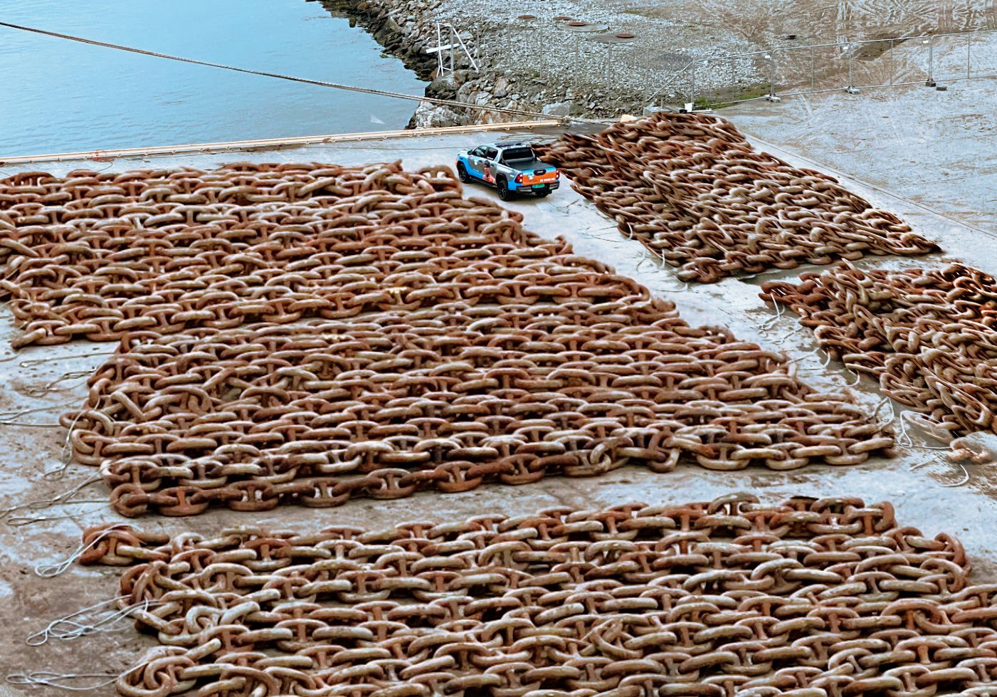 Giant really big chains next to a car in Norway